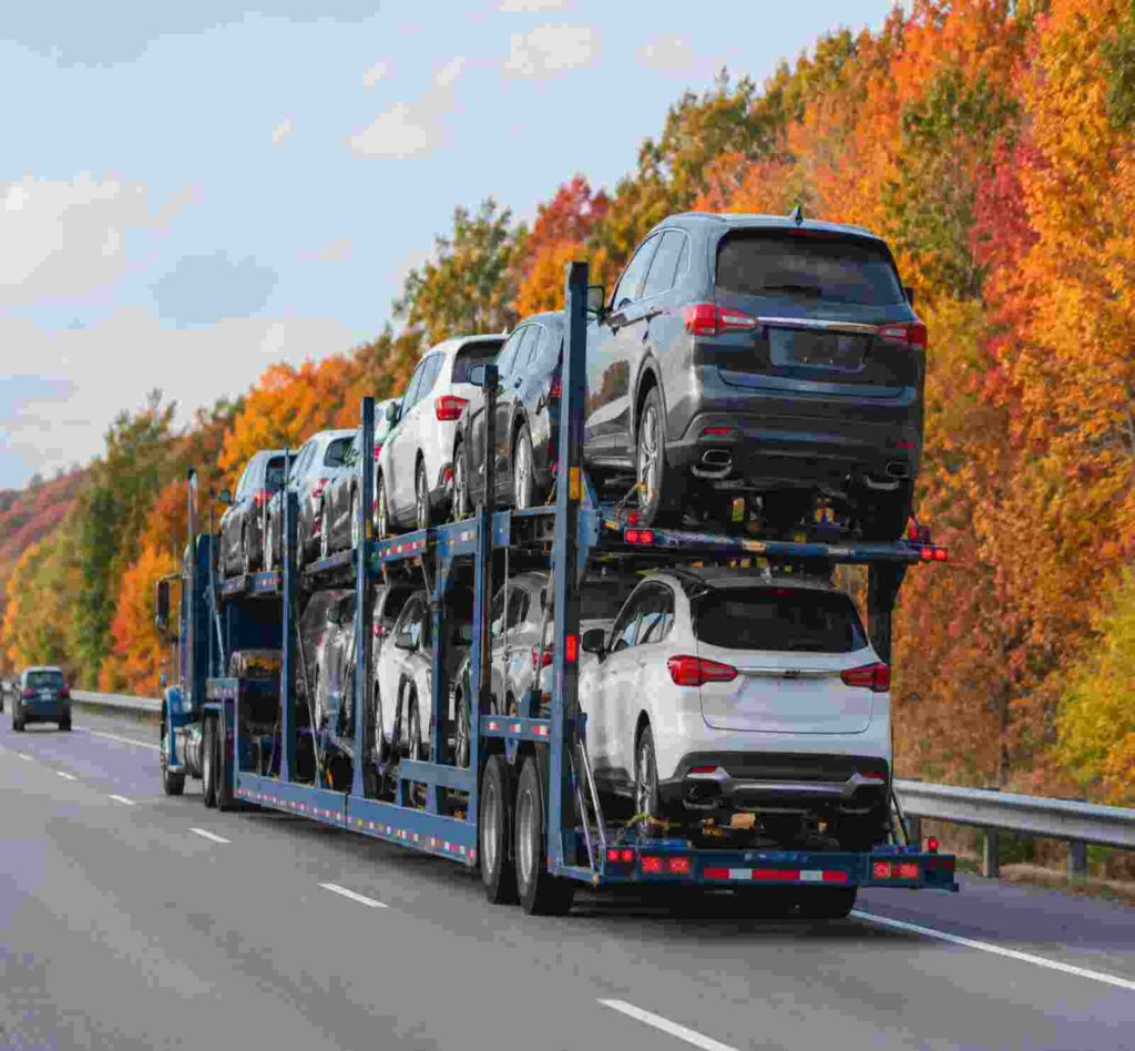 open car carrier taking the cars during fall season in november